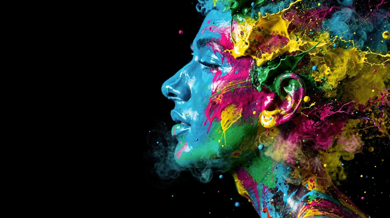 A face in profile dissolving into bursts of magenta, yellow, cyan and green paint against black.